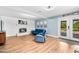 Open-concept living room with laminate floors, fireplace, and French doors to the outside at 6005 Lake Wheeler Rd, Raleigh, NC 27603