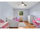 Charming bedroom featuring hardwood floors, light blue walls, and ample natural light at 6005 Lake Wheeler Rd, Raleigh, NC 27603