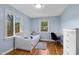 Cozy bedroom with hardwood floors, light blue walls, and natural light at 6005 Lake Wheeler Rd, Raleigh, NC 27603