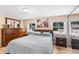 Comfortable bedroom with a geometric bedspread, hardwood floors, and dresser at 6005 Lake Wheeler Rd, Raleigh, NC 27603