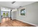 Dining room with modern lighting, wood flooring, and an open view of the backyard at 6005 Lake Wheeler Rd, Raleigh, NC 27603