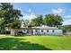 Charming single-story home with a lush lawn, a covered patio, and mature trees creating a welcoming curb appeal at 6005 Lake Wheeler Rd, Raleigh, NC 27603