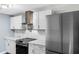 This modern kitchen features stainless steel appliances, white cabinetry, and quartz countertops at 6005 Lake Wheeler Rd, Raleigh, NC 27603