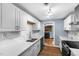 The modern kitchen is updated with stainless steel appliances, white cabinets, and quartz countertops at 6005 Lake Wheeler Rd, Raleigh, NC 27603