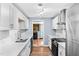 Modern kitchen with white cabinets, quartz countertops, and stainless steel appliances at 6005 Lake Wheeler Rd, Raleigh, NC 27603
