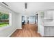 Open living space with wood floors, blue walls, and seamless transition between rooms at 6005 Lake Wheeler Rd, Raleigh, NC 27603