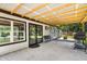 Covered patio with an outdoor kitchen, seating, and views of the backyard at 6005 Lake Wheeler Rd, Raleigh, NC 27603
