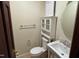 Cozy half bathroom with a toilet, sink, and storage cabinet at 609 Sloan Dr, Cary, NC 27511