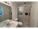 Bathroom featuring large glass door shower, white tile, and white vanity with large mirror at 609 Sloan Dr, Cary, NC 27511
