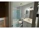 Bathroom featuring tub and shower combo with sky blue tiled walls, and white vanity and sink at 609 Sloan Dr, Cary, NC 27511