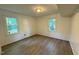 Bedroom with hardwood floors and neutral paint, two windows allowing for plenty of natural light at 609 Sloan Dr, Cary, NC 27511