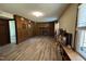 Living room with a fireplace, wood paneling, and built-in bookshelves by the windows at 609 Sloan Dr, Cary, NC 27511