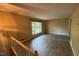 Living room with hardwood floors, large window, natural light and neutral paint throughout at 609 Sloan Dr, Cary, NC 27511