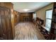 View of the living room with wood paneled walls, brick fireplace, and built-in bookshelves at 609 Sloan Dr, Cary, NC 27511