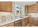 Naturally lit kitchen includes stainless dishwasher, quartz counters, and custom cabinetry at 610 Callan View Ave, Wake Forest, NC 27587
