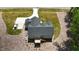 Aerial view of a single Gathering home with a backyard deck, paved driveway, and a car in the driveway at 620 Rollins Mill Rd, Holly Springs, NC 27540