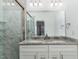 Modern bathroom with dual sinks, granite countertops, and a tiled shower at 620 Rollins Mill Rd, Holly Springs, NC 27540