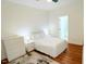 Bright bedroom with white furniture, a comfortable bed, and wooden floor at 620 Rollins Mill Rd, Holly Springs, NC 27540