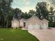 Charming home with a two-car garage, manicured lawn and natural surroundings at 620 Rollins Mill Rd, Holly Springs, NC 27540