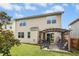 Home's backyard featuring a covered patio with chairs, a fire pit, and lush green grass at 634 Stapleford Ln, Fuquay Varina, NC 27526