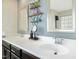 Bathroom with double sinks, modern fixtures, decorative shelves, and stylish mirrors at 634 Stapleford Ln, Fuquay Varina, NC 27526