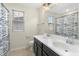 Modern bathroom with double sinks, a large mirror, and a decorative shower curtain at 634 Stapleford Ln, Fuquay Varina, NC 27526