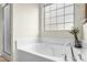 Bathroom with an oversized tub, brushed chrome fixtures, and neutral wall colors at 634 Stapleford Ln, Fuquay Varina, NC 27526