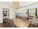 Open-concept dining room with modern chandelier, rustic wood table, and convenient access to other living areas at 634 Stapleford Ln, Fuquay Varina, NC 27526