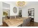 Dining room featuring a modern chandelier, a rustic wooden table, and views to other areas of the house at 634 Stapleford Ln, Fuquay Varina, NC 27526