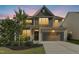 Charming two-story home featuring a well-manicured lawn and a two-car garage at sunset in a desirable neighborhood at 634 Stapleford Ln, Fuquay Varina, NC 27526