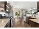 Modern kitchen with stainless steel appliances, granite countertops, and dark wood cabinets at 634 Stapleford Ln, Fuquay Varina, NC 27526