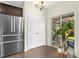 Eat-in kitchen area featuring stainless steel refrigerator and sliding door to the backyard at 634 Stapleford Ln, Fuquay Varina, NC 27526