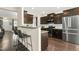 Stylish kitchen with granite countertops, stainless steel appliances, and a breakfast bar overlooking the living area at 634 Stapleford Ln, Fuquay Varina, NC 27526