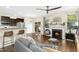 Bright and open living room with fireplace, kitchen view, and hardwood floors at 634 Stapleford Ln, Fuquay Varina, NC 27526