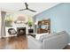 Cozy living room with fireplace, ceiling fan, and ample natural light at 634 Stapleford Ln, Fuquay Varina, NC 27526