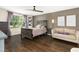 Comfortable main bedroom with wooden floors, ceiling fan, and plentiful natural light from the window at 634 Stapleford Ln, Fuquay Varina, NC 27526