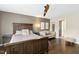 Comfortable main bedroom with wooden floors, ceiling fan, a plush bed, and a lovely seating area at 634 Stapleford Ln, Fuquay Varina, NC 27526