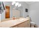 Bathroom with a large vanity and wood door entry at 701 Bennington Dr, Raleigh, NC 27615