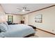 Bedroom with two windows, bed with a blue bedspread, and a ceiling fan at 701 Bennington Dr, Raleigh, NC 27615