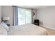 Peaceful bedroom with soft blue accents, carpeted floor, and ample natural light for a serene atmosphere at 701 Bennington Dr, Raleigh, NC 27615