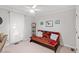 Cozy bedroom with carpet flooring, a ceiling fan, and a comfortable futon sofa for relaxation and style at 701 Bennington Dr, Raleigh, NC 27615