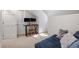 Bedroom area featuring a lounge sofa, desk with dual monitors, and a nearby closet at 701 Bennington Dr, Raleigh, NC 27615