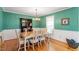 Traditional dining room with a formal dining table, hardwood floors, and green walls at 701 Bennington Dr, Raleigh, NC 27615