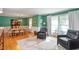 Elegant dining room featuring hardwood floors, green walls, and an adjacent seating area at 701 Bennington Dr, Raleigh, NC 27615