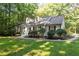 Classic home with a brick exterior, dormer windows, and a well-manicured lawn at 701 Bennington Dr, Raleigh, NC 27615