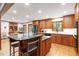 Elegant kitchen with granite countertops, wooden cabinetry, and a functional center island with bar stool seating at 701 Bennington Dr, Raleigh, NC 27615