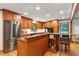 Well-lit kitchen with custom wood cabinets, granite counters, stainless steel appliances, and center island at 701 Bennington Dr, Raleigh, NC 27615