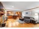 Open-concept living room featuring hardwood floors, a fireplace, and kitchen with bar seating at 701 Bennington Dr, Raleigh, NC 27615