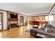 Spacious living area with a cozy fireplace, hardwood floors, and views into the kitchen area at 701 Bennington Dr, Raleigh, NC 27615