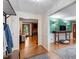 Open-concept living room with hardwood floors, a brick fireplace, and a view into the dining room at 701 Bennington Dr, Raleigh, NC 27615